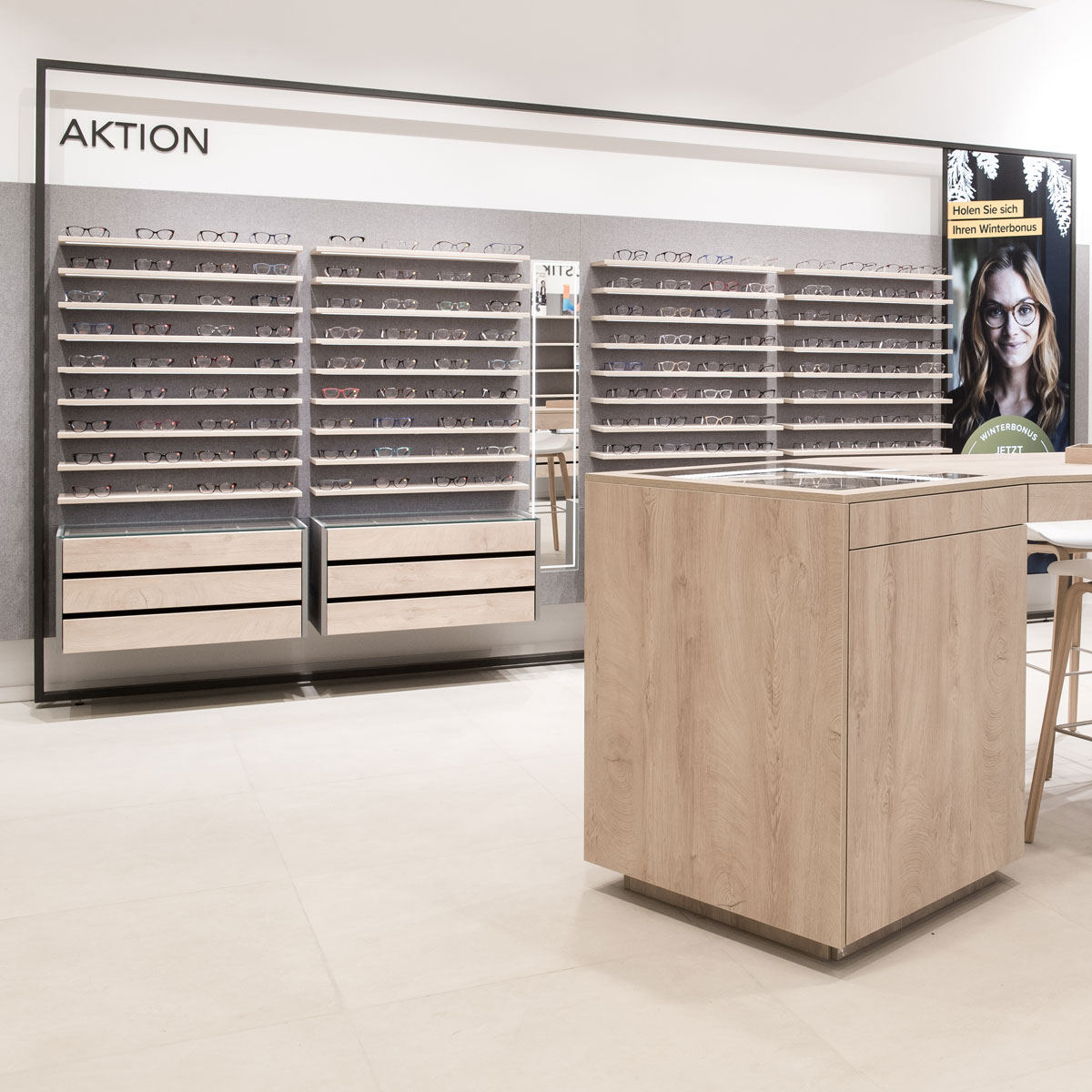 Brillenwand im Optikerladen mit Aktionsbereich und Präsentationsregalen